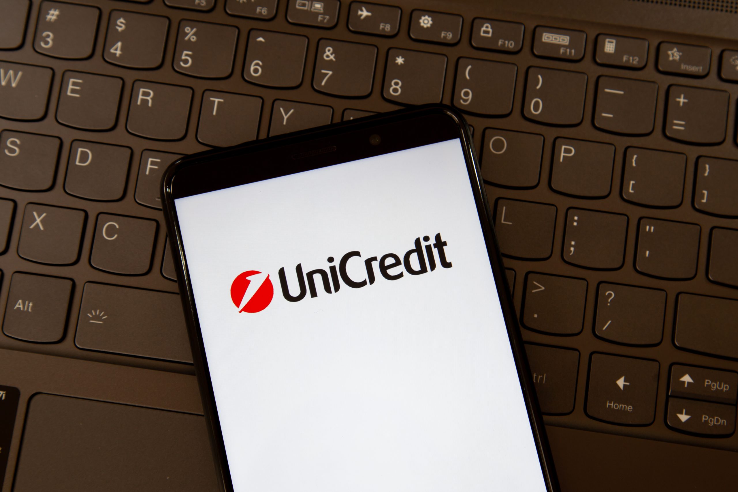 Toronto, On, Canada - December 19, 2021: UniCredit logo on smartphone screen on a keyboard. UniCredit S.p.A. is an international banking group headquartered in Milan.
