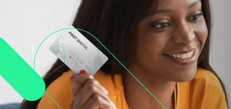 woman holding a First Digital Mastercard